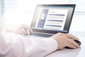 Person in front of computer finding a job in a new city