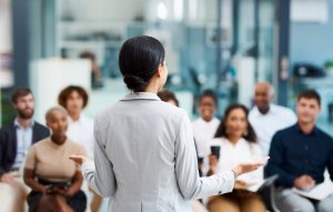 A female CEO and her employees are discussing how to help their company craft and hone their employer's brand.