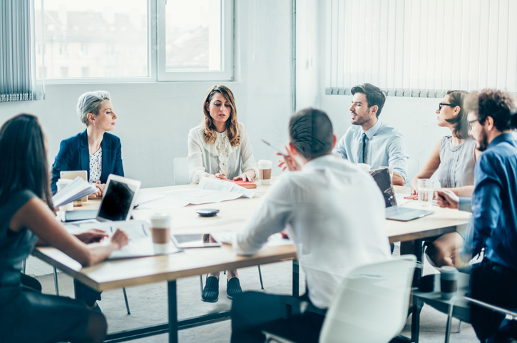 A group of employees, along with their employer, is discussing upskilling and reskilling to build a strong future workforce.