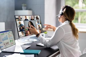 The female representative of a recruitment agency maintains strong connections with candidates to help the company find the best talent for remote positions.