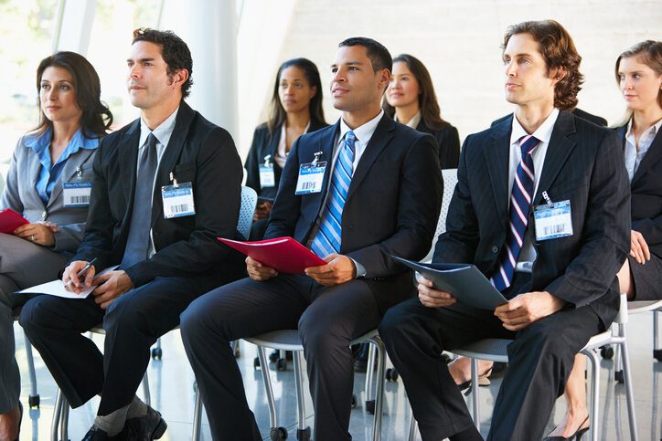 A group of employees sitting in a waiting area for their interview, representing employer branding attracting top talent.