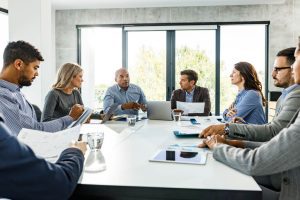 A group of employees sitting in a circle during a team discussion, representing retaining top talent strategies in the workplace.