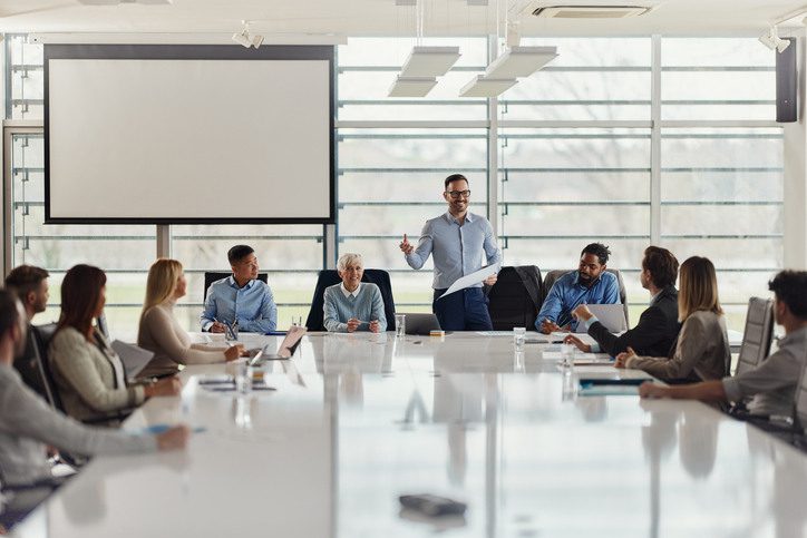 A group of employees sitting in a circle during a team discussion, representing retaining top talent strategies in the workplace.