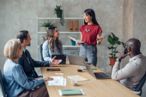 Employee leasing vs temporary staffing team meeting with business professionals discussing workforce strategy and hiring solutions in a modern office setting.