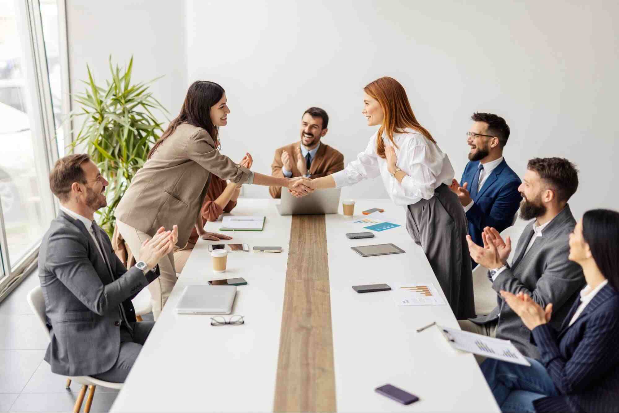 New employee being welcomed by a team, illustrating why new hires leave when expectations and role alignment fall short.